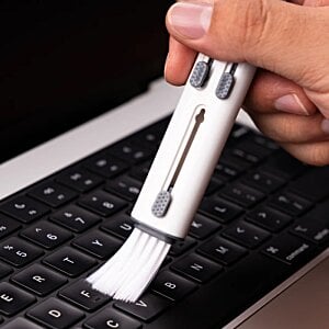 Additional Image 2 - a hand holding a white brush over a keyboard