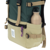 a green and tan backpack with a bottle inside