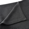 a black cloth folded on a white surface