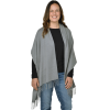 a woman wearing a grey poncho