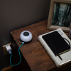 a table with a tablet and a white round object on it