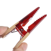 a person holding a pair of red pliers