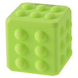 a green toy cube with holes