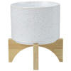 a white pot on a wooden stand