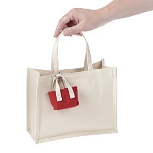 a hand holding a white bag