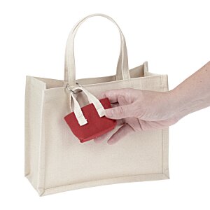 a hand holding a white bag