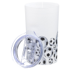 a white cup with black dots and a circle