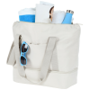 a white bag with a strap and sunglasses