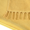 a yellow blanket with tassels