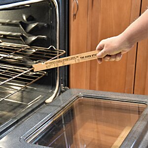 Additional Image 2 - a hand holding a wooden stick over an oven
