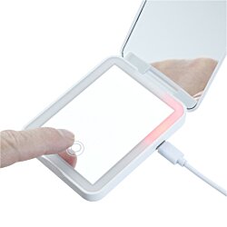 a hand holding a small device