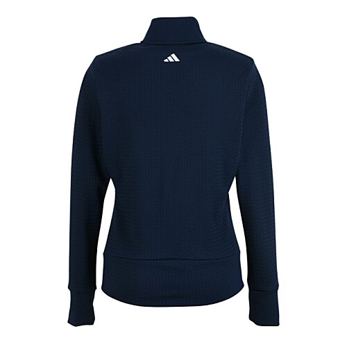 Additional Image 1 - a blue sweater with a white logo