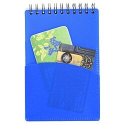 a blue spiral notebook with a green card and a green card inside