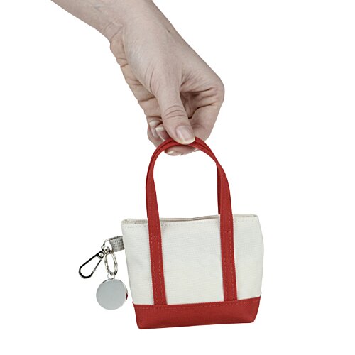 Additional Image 1 - a hand holding a small red and white bag