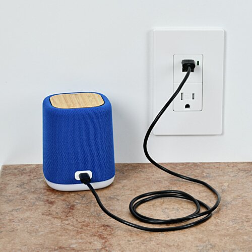 Additional Image 3 - a blue speaker plugged into a wall outlet