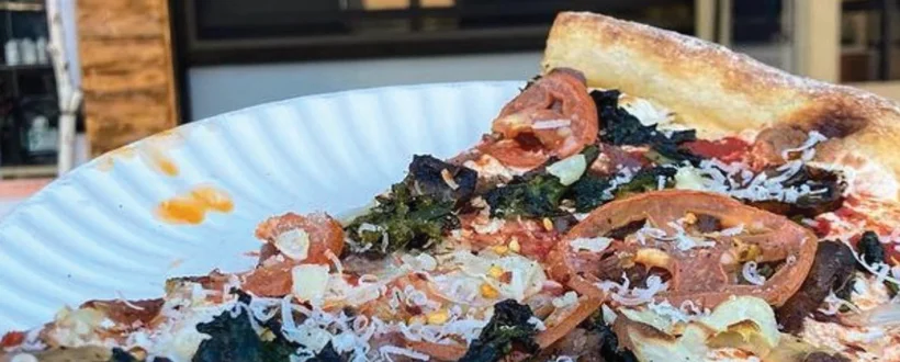 A plate of pizza with cheese and vegetables