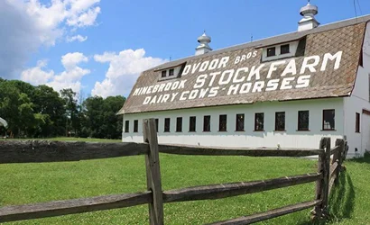 white barn with advertising painted on roof