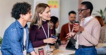 Three teachers talking in the breakroom.