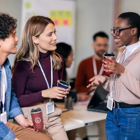 Three teachers talking in the breakroom.