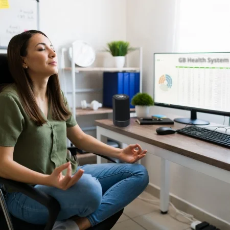 Person sitting at their desk meditating.
