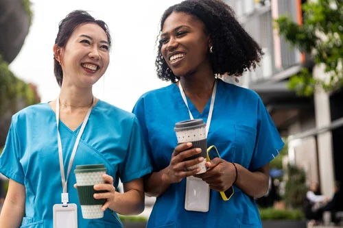 two nurses walking down the street talking