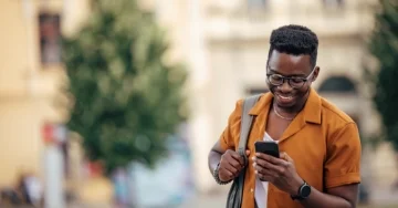 Person walking and texting on their phone. 