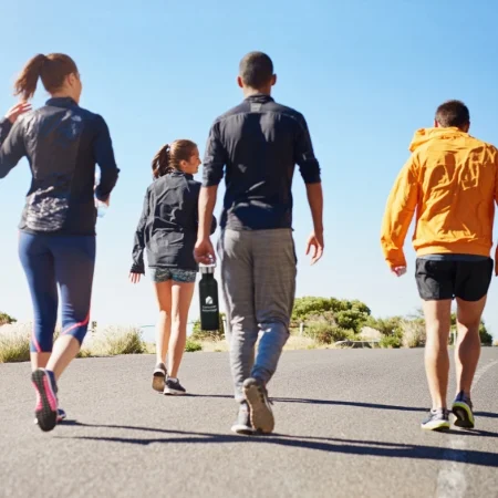 Group of people out for a walk on the road during the day.