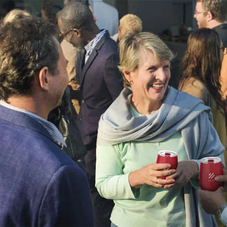 A group of people at an event using wine tumblers