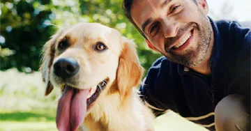 photo of a man with a golden retriever dog