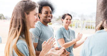 group of people clapping their hands