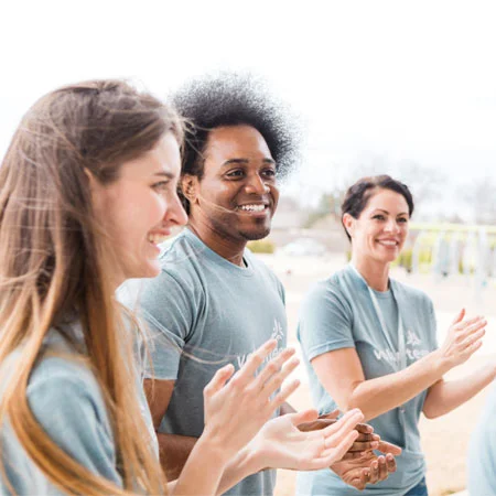 group of people clapping their hands