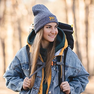 Woman wearing a beanie walking in the woods