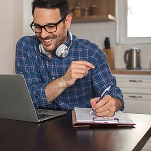 Man writing in a journal with a gel pen