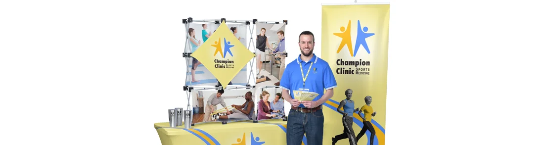 Promotional trade show items that include a vertical banner, display and table throw