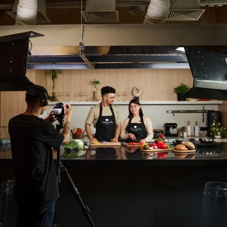 Two chefs filming a promotional video.