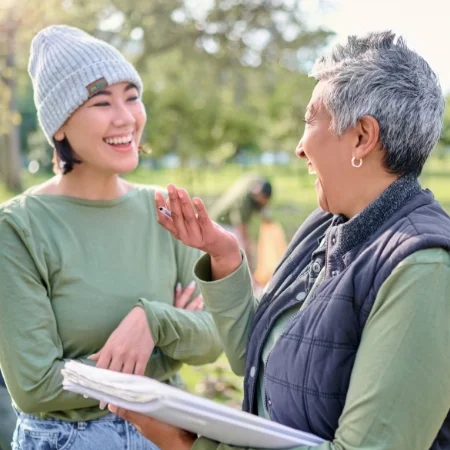 Two volunteers talking during a break at a park