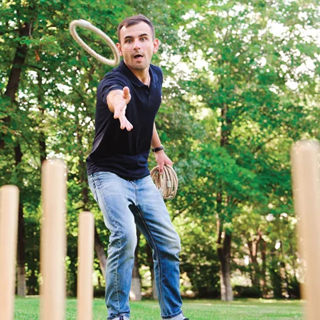 Man playing ring toss outside