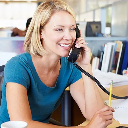 Woman talking on phone at desk