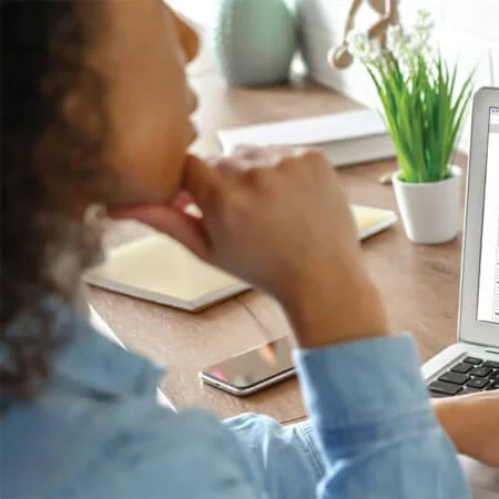 Woman working at computer at her desk