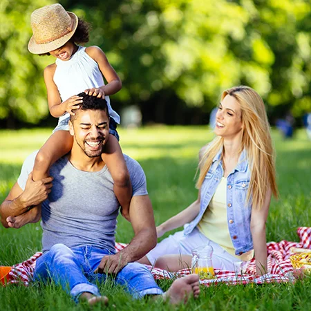 Couple sitting at a picnic with child
