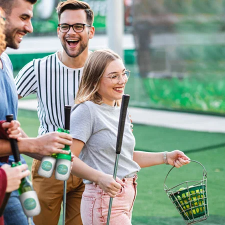 A small group of people playing golf
