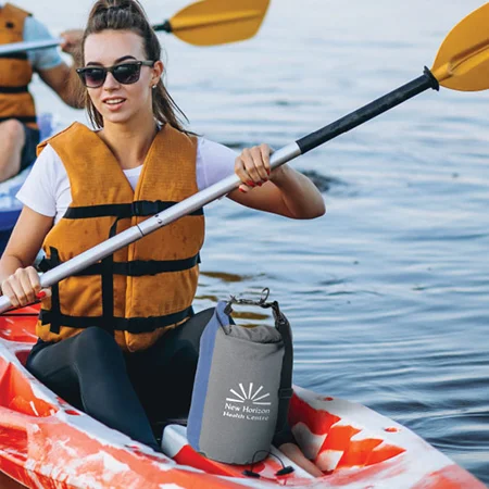 Woman kayaking with a cooler in here kayak