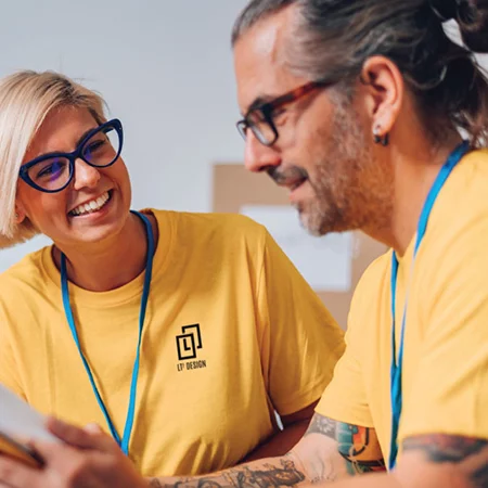 Woman talking with a co-worker wearing a t-shirt with their logo