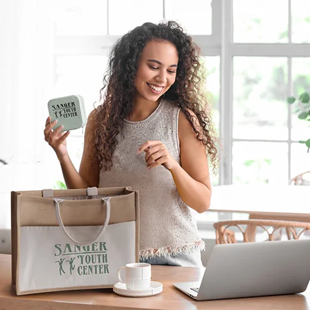A woman taking items out of a reusable bag