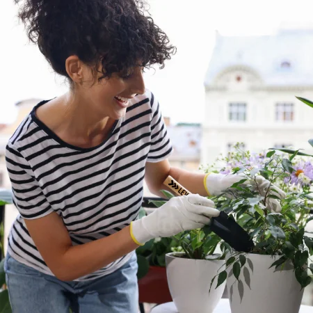 Woman gardening with a shovel in a planter