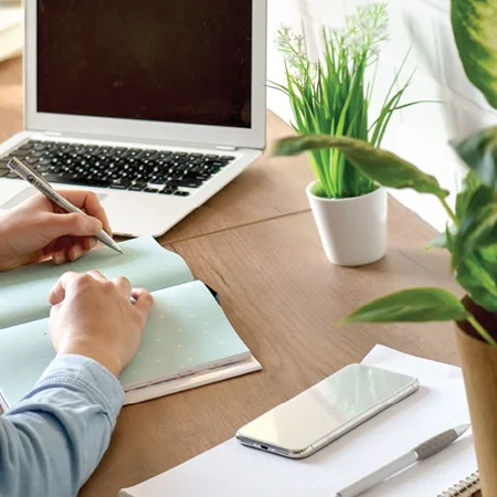 Woman writing at the computer desk