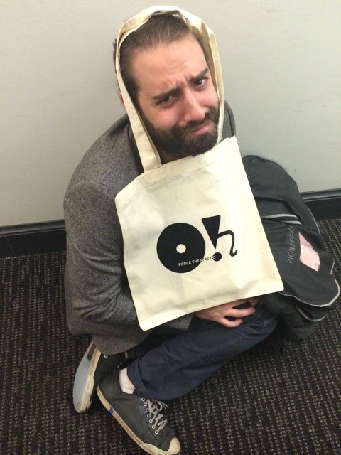 a man sitting on the floor with a bag over his head