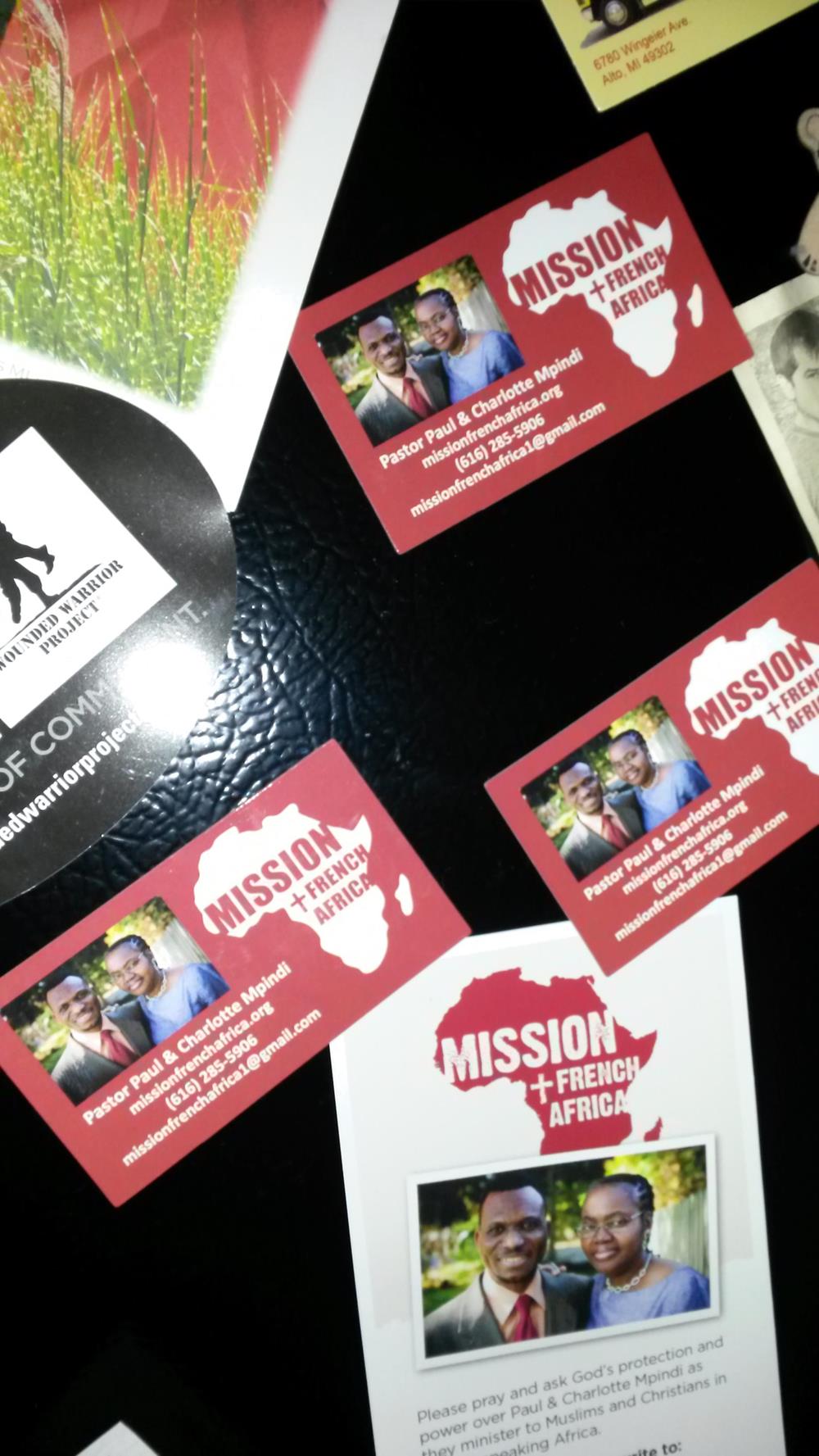 Customer photo from Sue of our Business Card Magnet - 30 mil, a group of business cards on a black surface