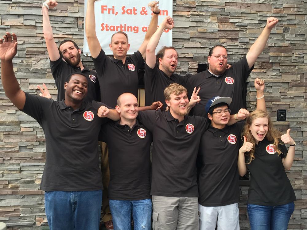 Customer photo from Mark of our Harriton 6-oz Ringspun Cotton Pique Polo - Men's - Embroidered, a group of people posing for a photo