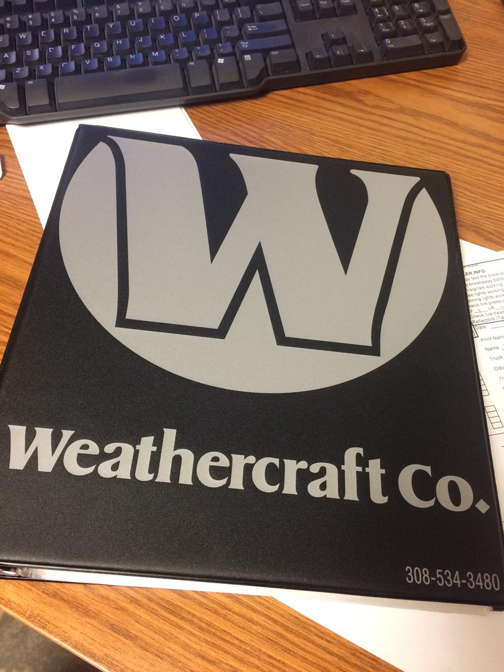 Customer photo from Maggie of our Vinyl Ring Binder - 1-1/2", a black folder with a white w on it